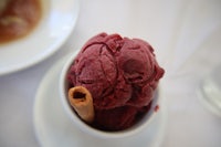 a bowl of red velvet ice cream with a cinnamon stick