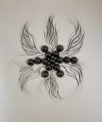 a black and white sculpture with a lot of black beads