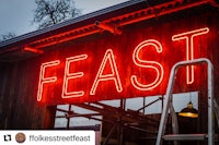 a red neon sign with the word feast on it