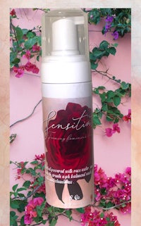 an image of a bottle with a rose on it