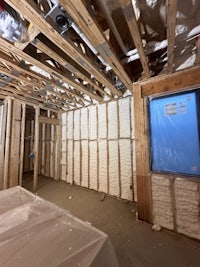 a room that is being remodeled with wood framing