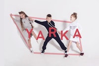 a group of children are posing in front of a sign that says yarka