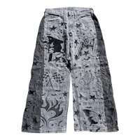 a pair of denim pants with designs on them