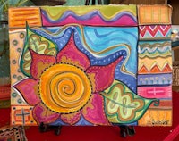 a colorful painting of a flower on a stand