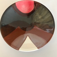 a plate with a black, brown and red design