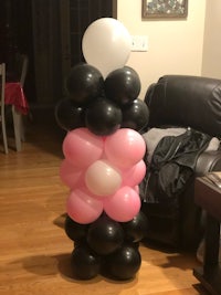 a black and white balloon tower in a living room