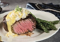 a steak on a plate with asparagus on it