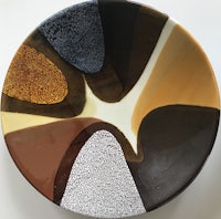 a plate with a brown, black, and white design