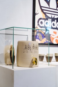 a display of mugs and bowls in a glass case