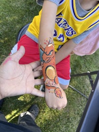 a boy with a tattoo on his arm