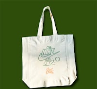 a white tote bag with the word nike on it