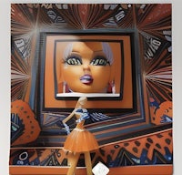 a girl in an orange dress is standing in front of an orange frame