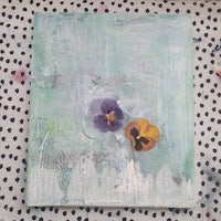 a painting of two pansies on a polka dot background