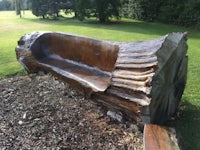a bench made out of a tree trunk