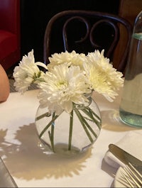 white flowers in a vase on a table