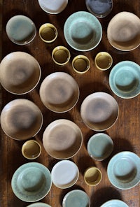 a collection of plates and bowls on a wooden table