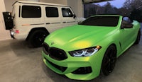 a green bmw coupe and a green mercedes benz
