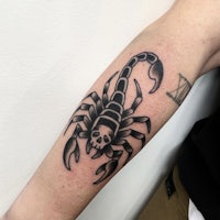 a scorpion tattoo on the forearm