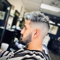 a man with grey hair in a barber shop