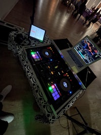 a dj set up on a table with a laptop on it
