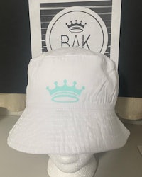 a white bucket hat with a crown on it
