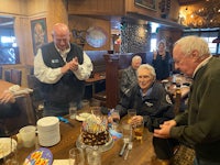 a group of people celebrating a birthday in a restaurant