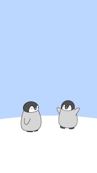 two penguins standing on a snowy field