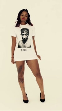 a woman wearing a t - shirt with a picture of tupac