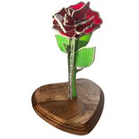 a stained glass rose on a wooden base