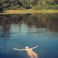 a naked woman floating in a body of water