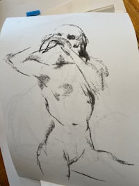 a drawing of a nude woman sitting on a table