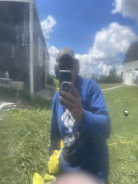 a man taking a selfie in the grass
