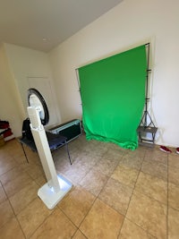 a room with a green screen and a chair