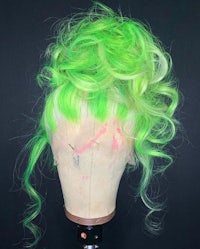 a green wig on a mannequin head