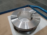 a stainless steel ring on a table in a factory