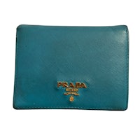 a blue prada wallet on a white background
