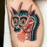 a dragon tattoo on a man's leg
