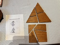 two triangles on a table next to a piece of paper
