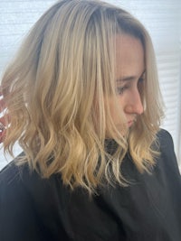a blonde woman getting her hair done in a salon