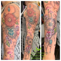 a woman's sleeve tattooed with colorful flowers