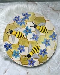 a plate with bees and flowers on it