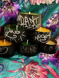 a group of black candle holders with words written on them