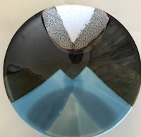 a plate with a blue and brown design on it