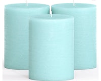 three blue pillar candles on a white background
