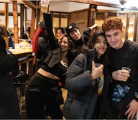 a group of people posing for a picture in a bar