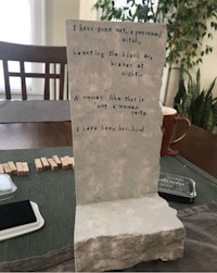 a piece of paper with a poem on it sitting on a table