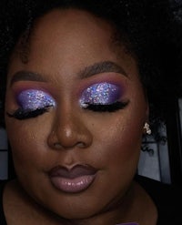 a woman with purple and purple eyeshadow on her face