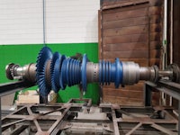 a blue gear is sitting on a table in a factory