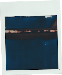 a polaroid photo with a blue background