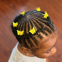 a little girl with yellow butterflies in her hair
